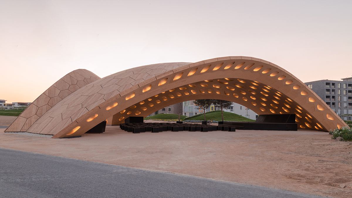 BUGA Wood Pavilion: Side view of the shell with lit openings