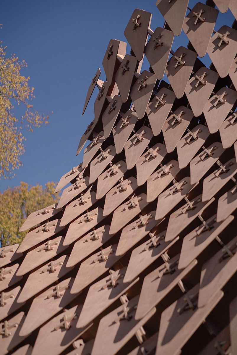 Dragon Skin Pavilion: Shingled surface rising against the sky