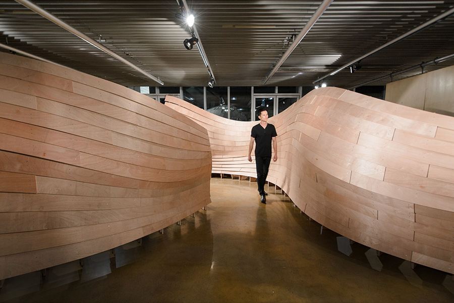 Robot-Assisted Assembly in Wood Construction: Visitor walking through the timber structure