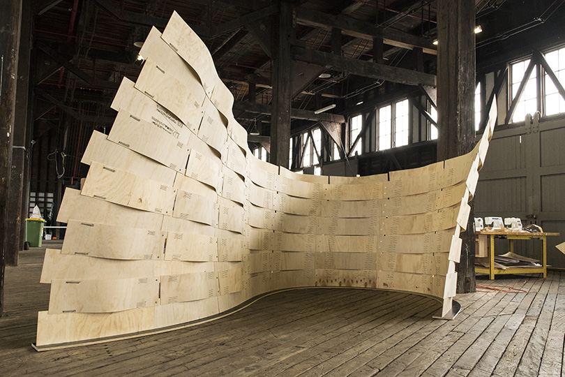 Robotic Sewing of Elastically Bent Plywood: Curved sewn plywood surface in a hall