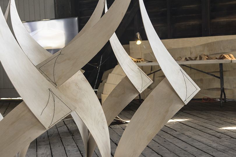 Robotic Sewing of Elastically Bent Plywood: Bent plywood strips during assembly